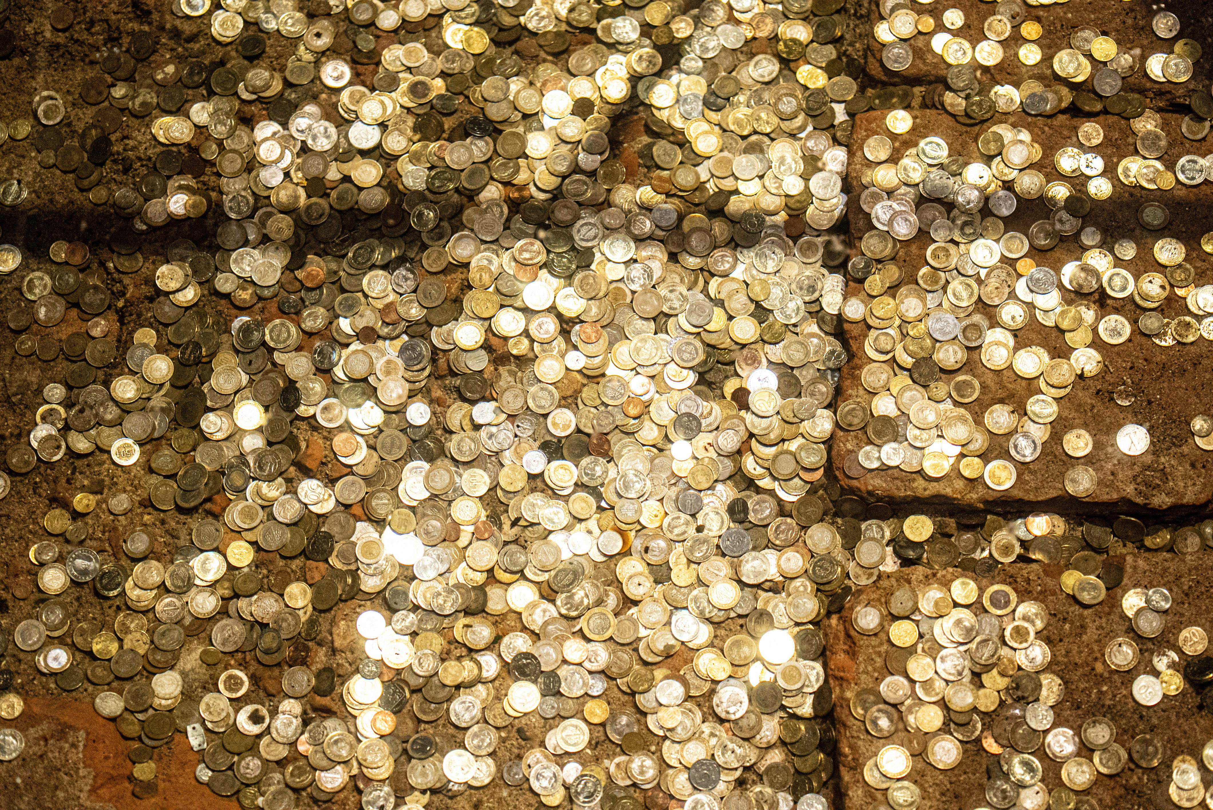 a pile of gold and silver coins